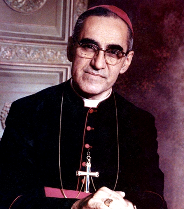 Photograph of Archbishop Óscar Romero in clerical dress and glasses, facing the camera with a calm, tired expression.